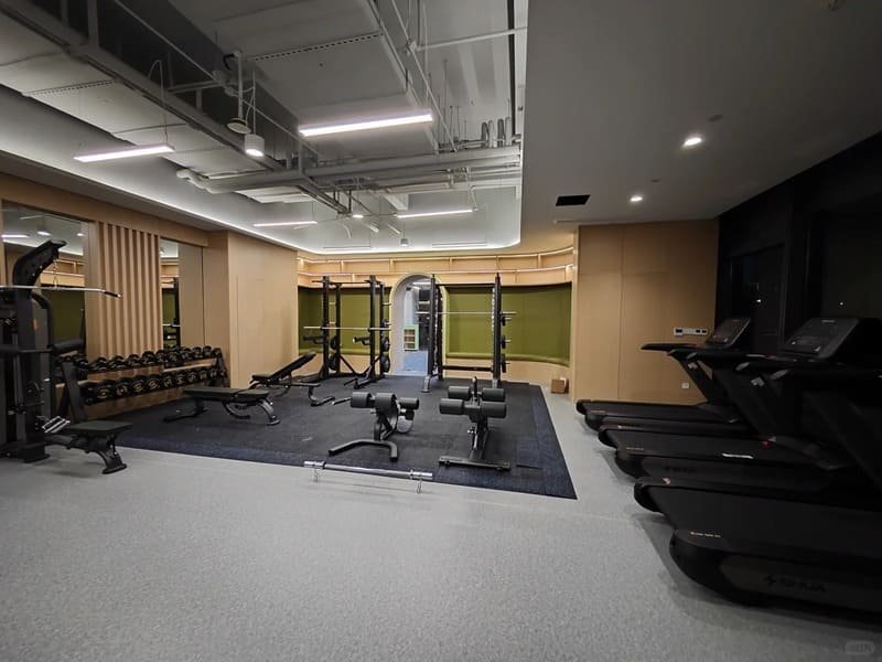A shipping container with gym flooring rolls being loaded onto a truck in the EU.